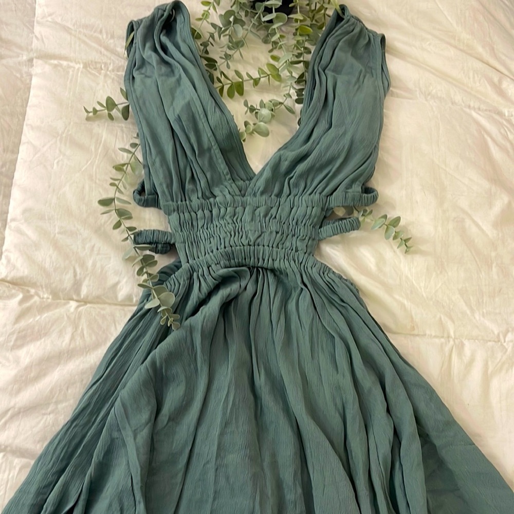 Super cute plunge v-neck skater dress in sage green! Cutouts on the sides